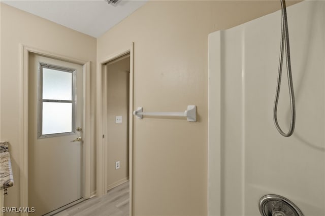 bathroom featuring walk in shower and hardwood / wood-style floors