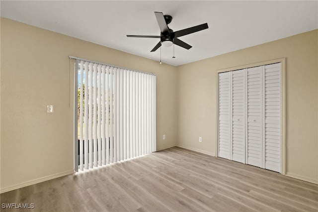 unfurnished bedroom featuring a closet, ceiling fan, and light wood-type flooring