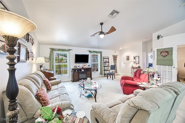 carpeted living room with ceiling fan