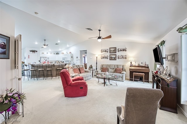 carpeted living room featuring vaulted ceiling and ceiling fan