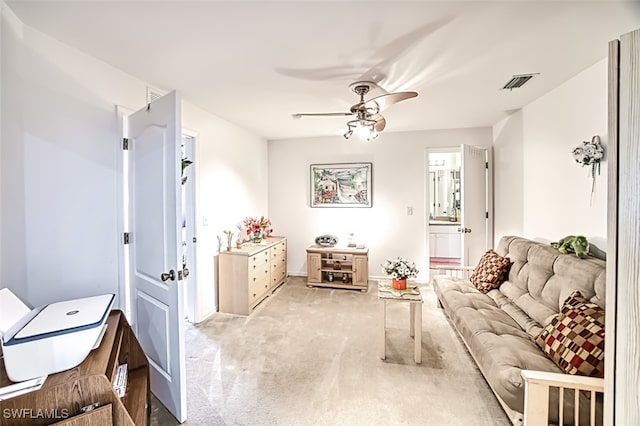 carpeted living room with ceiling fan