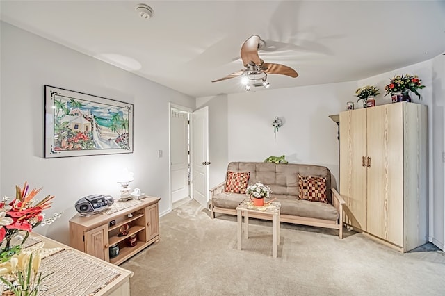 sitting room featuring ceiling fan and light colored carpet