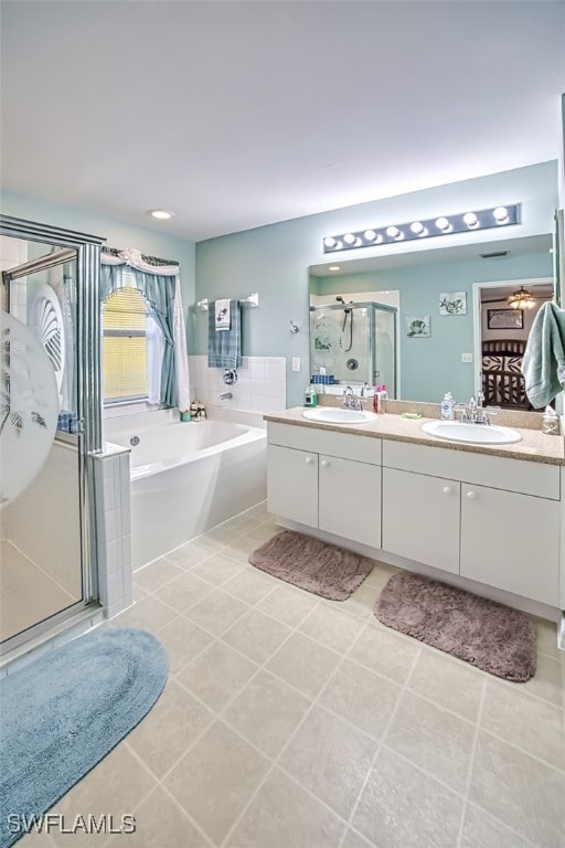 bathroom with shower with separate bathtub, tile patterned floors, and vanity