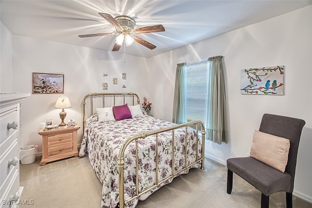 bedroom with ceiling fan and light carpet