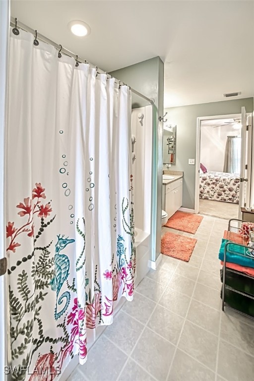 bathroom featuring tile patterned flooring, vanity, and shower / tub combo