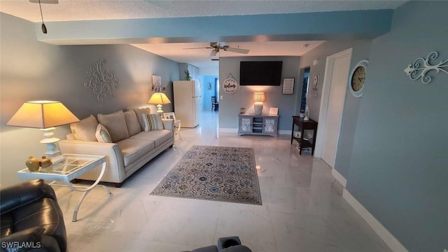 living room featuring a textured ceiling and ceiling fan