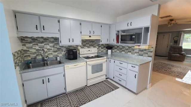 kitchen with sink, gray cabinetry, white appliances, and decorative backsplash