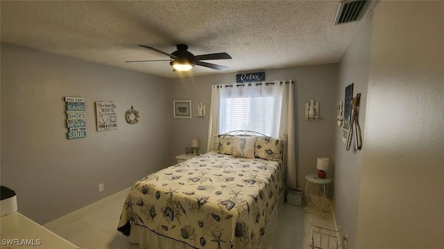 bedroom with a textured ceiling and ceiling fan