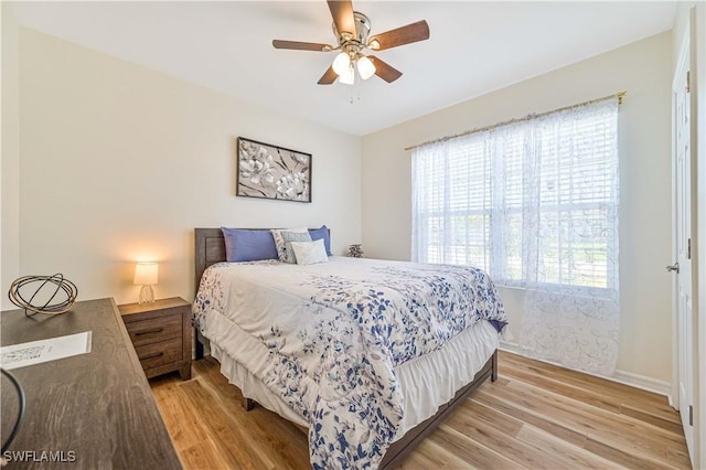 bedroom featuring light hardwood / wood-style floors and ceiling fan