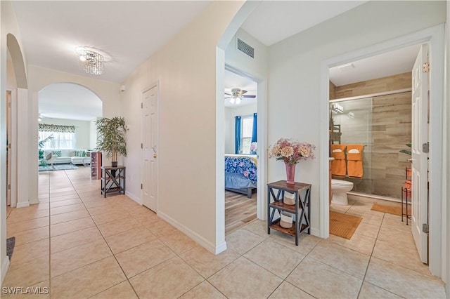 hall with light tile patterned floors