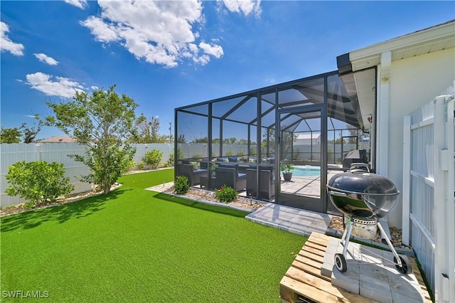 view of yard with a fenced in pool, a patio area, and glass enclosure