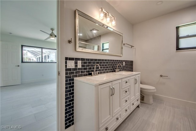 bathroom with ceiling fan, vanity, toilet, and tile patterned flooring