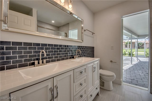 bathroom with vanity, tile patterned flooring, decorative backsplash, and toilet