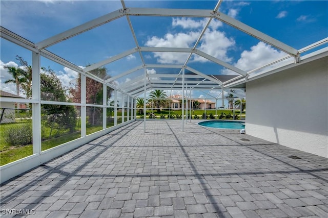 view of swimming pool featuring a lanai and a patio area