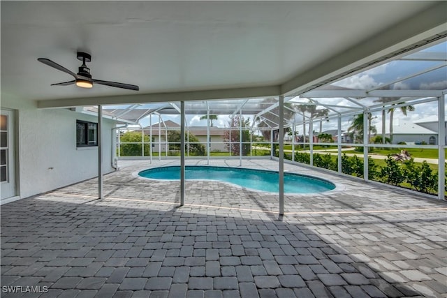 view of swimming pool featuring a lanai and a patio area