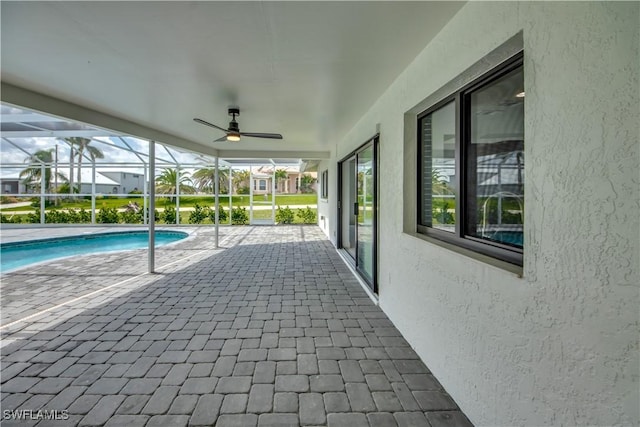 view of swimming pool with a patio and a lanai