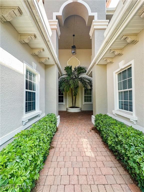 doorway to property with stucco siding