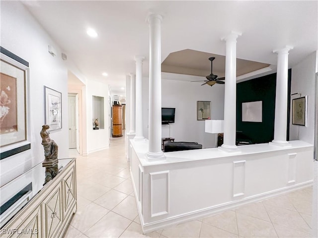 living room featuring ornate columns, a ceiling fan, and light tile patterned floors