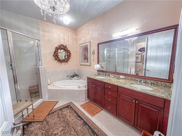 bathroom featuring tile patterned floors, independent shower and bath, vanity, and a notable chandelier