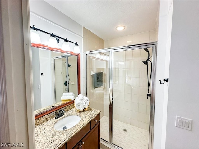 bathroom featuring vanity and a shower with shower door