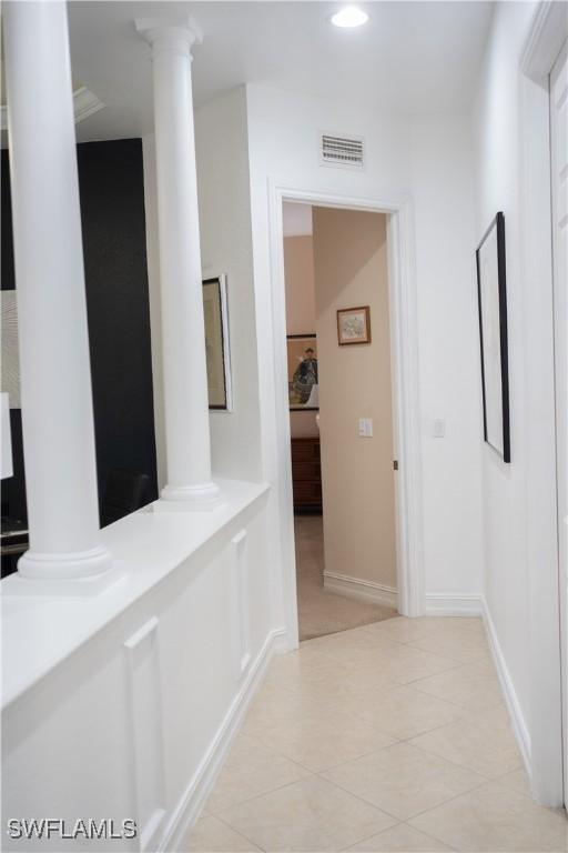 hallway featuring decorative columns, recessed lighting, light tile patterned flooring, and visible vents