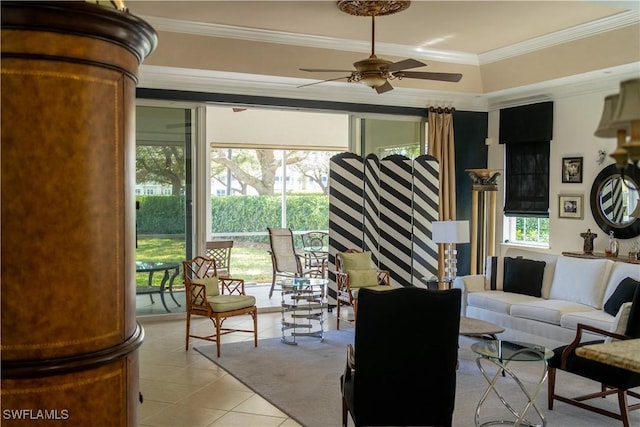 living area with ornamental molding, a ceiling fan, and light tile patterned floors