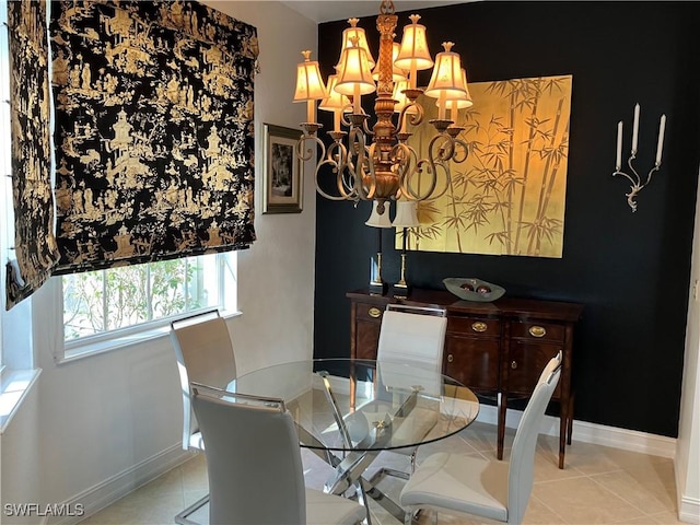 dining room with light tile patterned floors, baseboards, and a chandelier