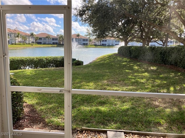 view of yard featuring a water view and a residential view