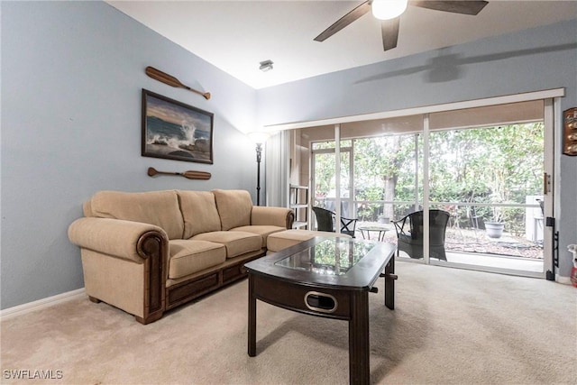 living room featuring light colored carpet and ceiling fan