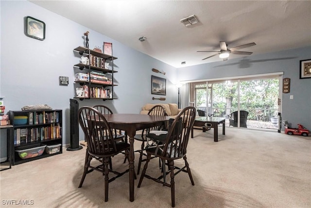 dining space featuring carpet and ceiling fan