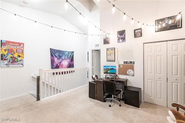 carpeted office featuring high vaulted ceiling