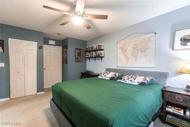 carpeted bedroom featuring ceiling fan and a closet