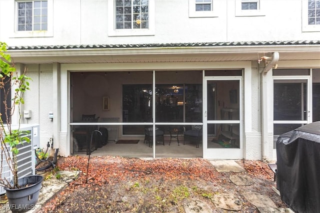 property entrance featuring a patio and central AC unit