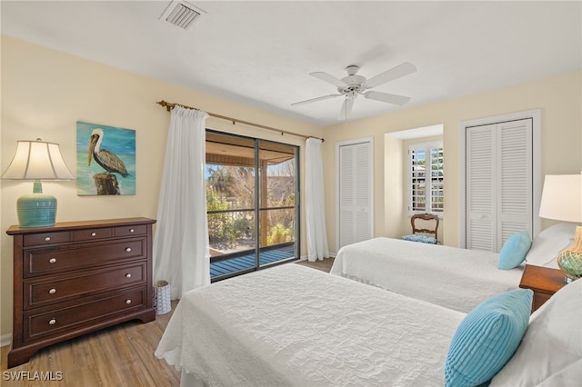 bedroom with multiple closets, ceiling fan, light wood-type flooring, and access to outside