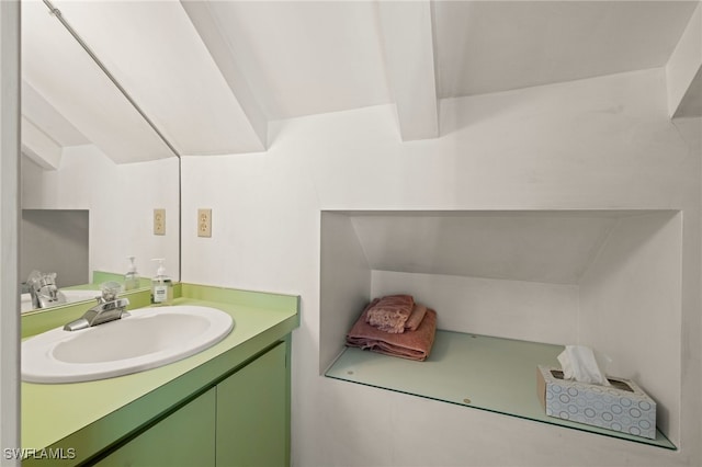 bathroom with vanity and vaulted ceiling with beams