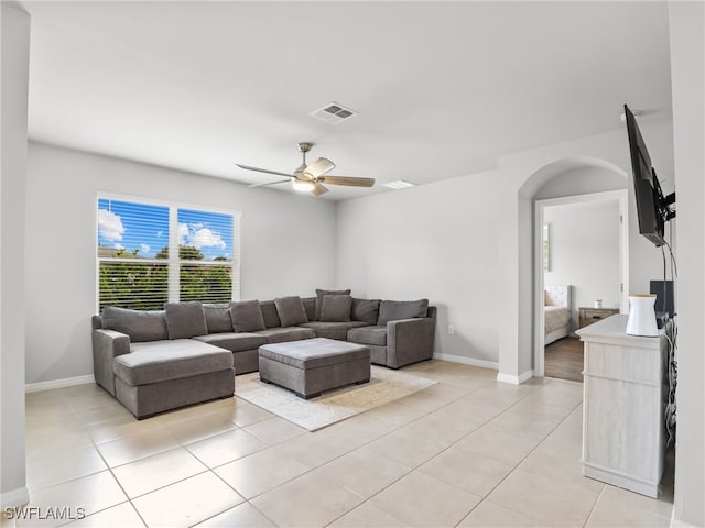 tiled living room with ceiling fan