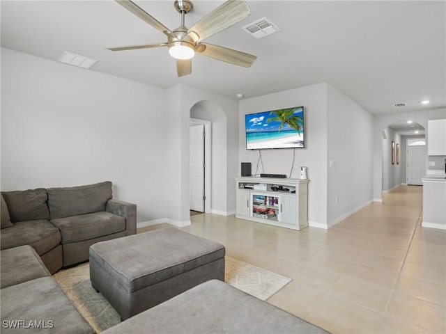 tiled living room featuring ceiling fan