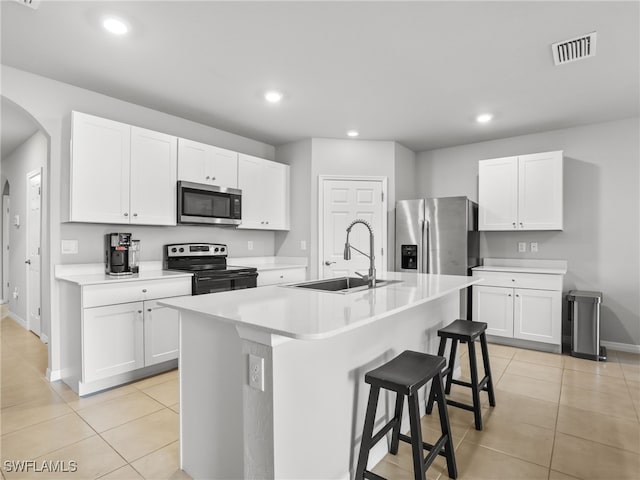 kitchen featuring white cabinetry, sink, an island with sink, and appliances with stainless steel finishes