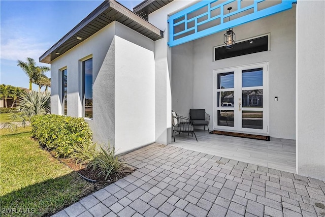 doorway to property with french doors and stucco siding