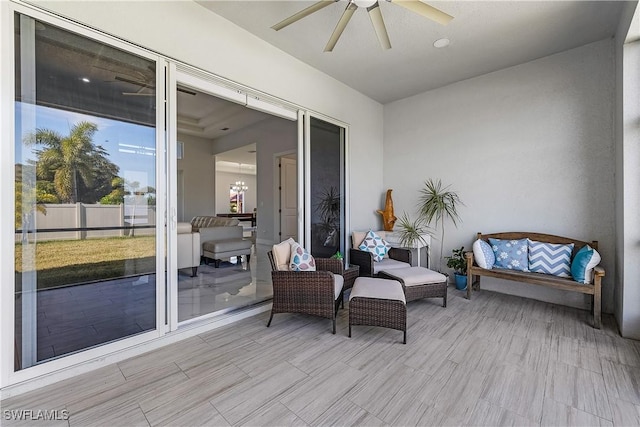 exterior space featuring ceiling fan with notable chandelier