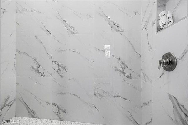 room details featuring a marble finish shower