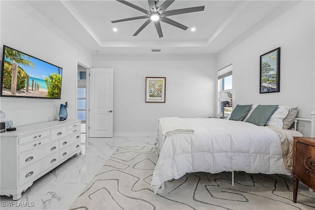 bedroom featuring marble finish floor, visible vents, a raised ceiling, and recessed lighting