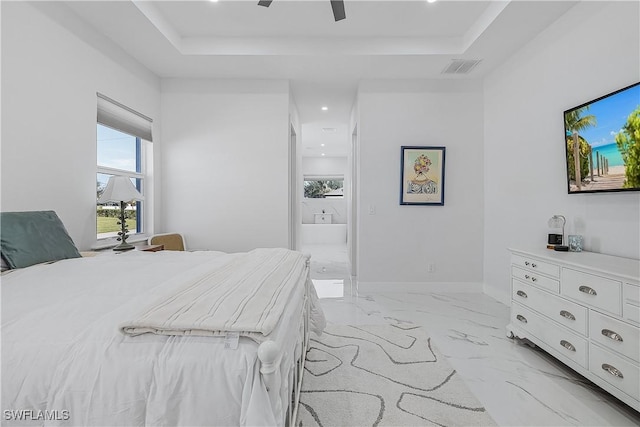 bedroom with baseboards, visible vents, a raised ceiling, connected bathroom, and marble finish floor