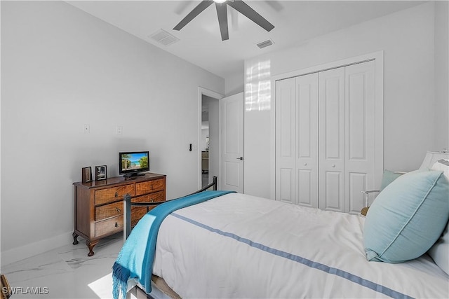 bedroom featuring marble finish floor, a closet, visible vents, and baseboards