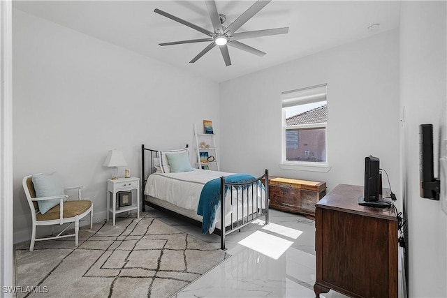 bedroom with marble finish floor and a ceiling fan