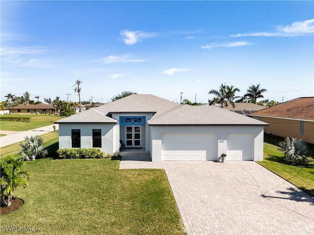 view of front of property featuring decorative driveway, stucco siding, a shingled roof, a front yard, and a garage