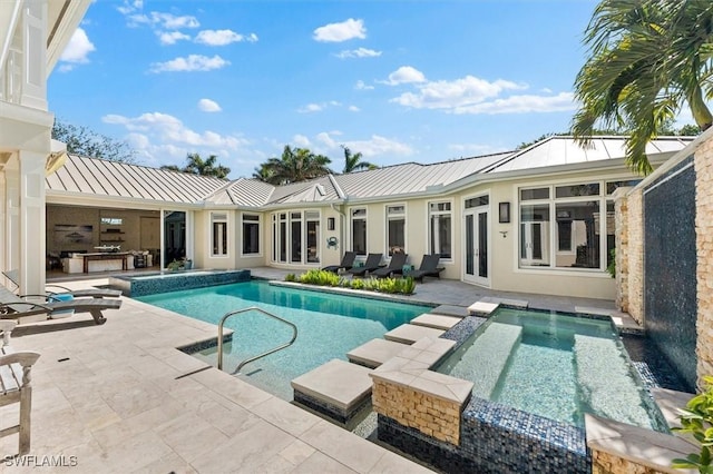 view of pool with an in ground hot tub and a patio