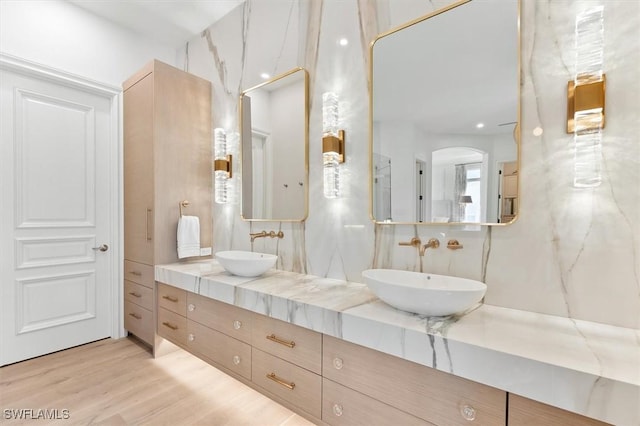 bathroom with hardwood / wood-style flooring and vanity