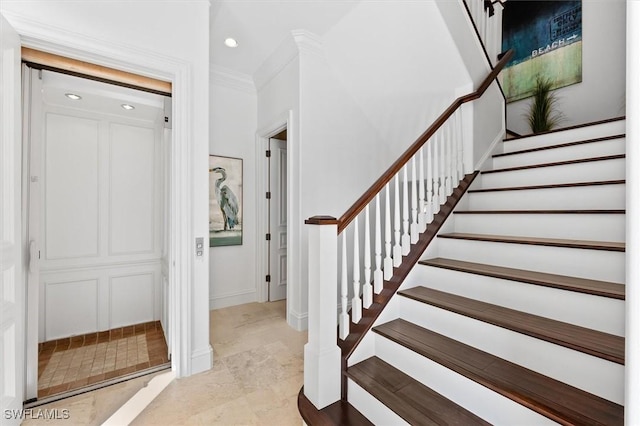 staircase featuring crown molding