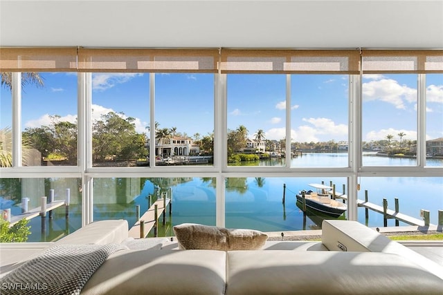 sunroom / solarium featuring plenty of natural light and a water view